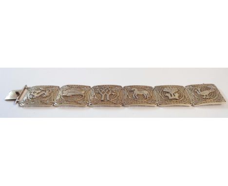 A marked sterling five filigreed panel with various applied motifs including dragon, fishes, and other animals