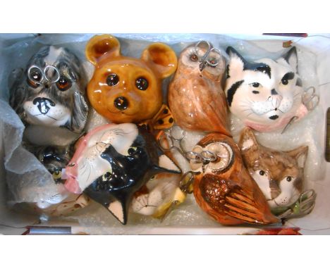 A box containing a collection of nine vintage Babbacombe pottery string holders