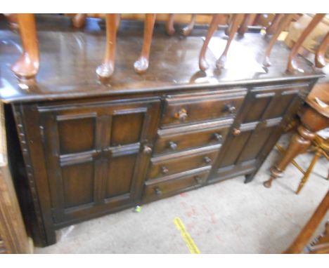 A 1.4m vintage dark Ercol sideboard with four central drawers and flanking cupboard doors