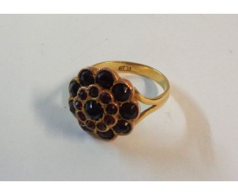 A marked 18c rose metal garnet cluster ring - boxed