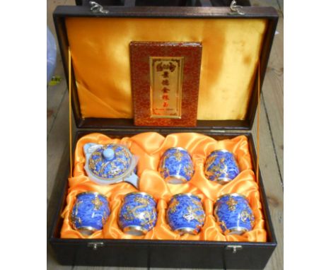 A Guo Bin Li Pin Jin Xiang Yu modern Chinese tea set with blue and white scroll decoration and brass decorative overlay conta