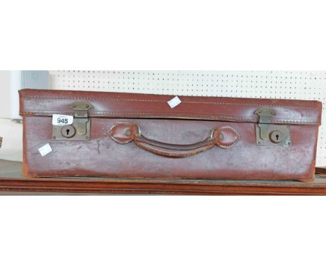 A vintage leather suitcase with brass locks