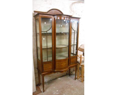 A 1.15m Edwardian inlaid mahogany break bow front display cabinet with material lined interior enclosed by flanking doors, se