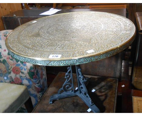 A 60cm diameter 20th Century Islamic tray style table top, set on a painted cast iron trefoil base