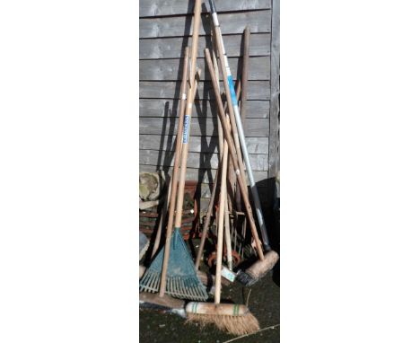 A selection of old tools including forks, rake, brushes, etc.