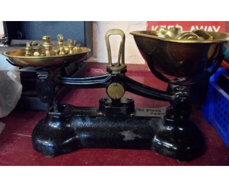 A set of Libra Scale Co. cast iron scales with brass pans and set of brass weights