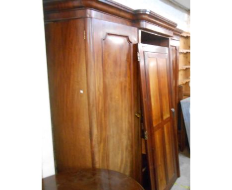 A 2.2m 19th Century mahogany break front triple wardrobe with central linen slides and drawers enclosed by a mirror panel doo