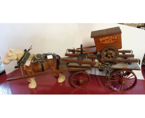 A vintage ceramic cart horse with wooden cart and associated bakers' cart