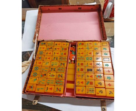 A vintage mah-jong set with butterscotch phenolic playing tiles, counters, markers, die, etc. in original card box