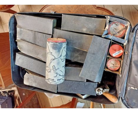 A suitcase containing a vintage Map-o-graph map making kit and a large quantity of rolls