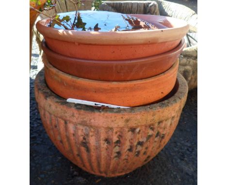 A small terracotta garden planter of reeded form - sold with two other garden plant pots