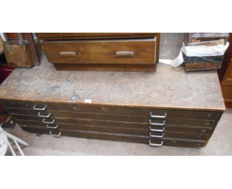 A 1.47m vintage stained pine and mixed wood plan chest of five long drawers