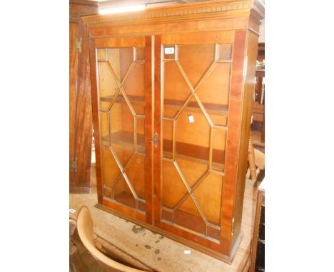 A 76cm reproduction yew wood bookcase top with shelves enclosed by a pair of astragal glazed panel doors