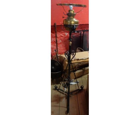 A Victorian oil lamp standard with brass reservoir and remains of Lampe Veritas burner with wrought iron base and brass flowe