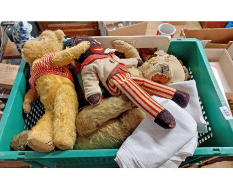 A crate containing a quantity of vintage teddies and other soft toys including straw filled examples, Sunny Jim advertising f