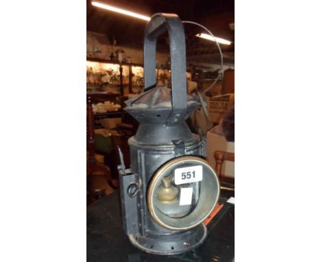 An antique railway hand lamp with black painted finish