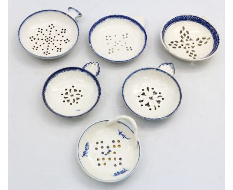 Six English porcelain egg strainers of circular form, decorated with blue and white transfer prints, each with individual dra
