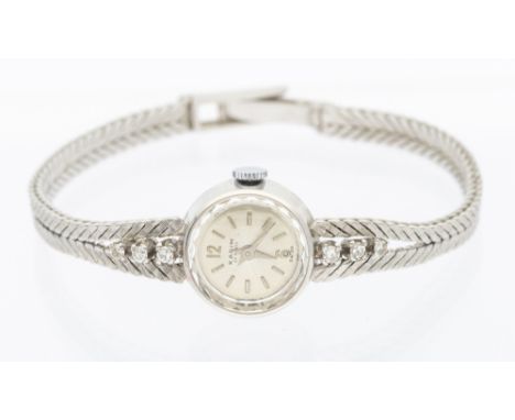 A ladies vintage diamond set 18ct white gold Karim 17 'rubis' manual wristwatch, comprising a round silvered dial with baton 