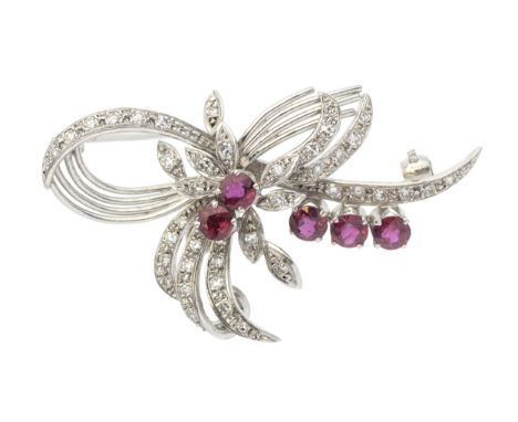 A vintage ruby and diamond set 18ct white gold spray brooch, bow and foliate decoration set with grain set diamonds, and claw