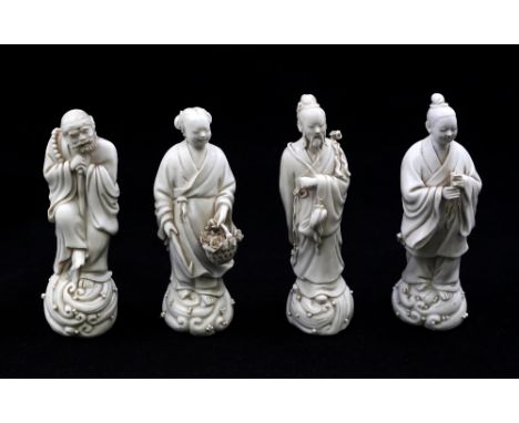 A collection of four 20th century Chinese blanc-de-chine figures of Immortals or Villagers, each with detailed features and h