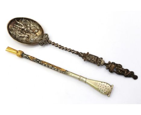 An early 20th century Dutch silver presentation spoon, with embossed figural bowl, with crest and twisted stem, import marks 