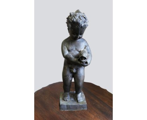 A 20th century cast spelter figure / water feature of a young nude boy holding a fish, upon a square base, with pipe from bac