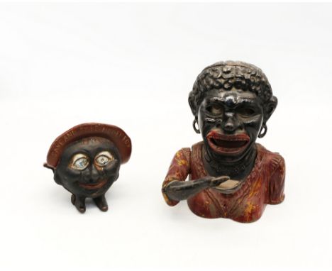 An early 20th century novelty cast iron 'Save and Smile' money box, together with a larger example titled to back 'Dinah' . (