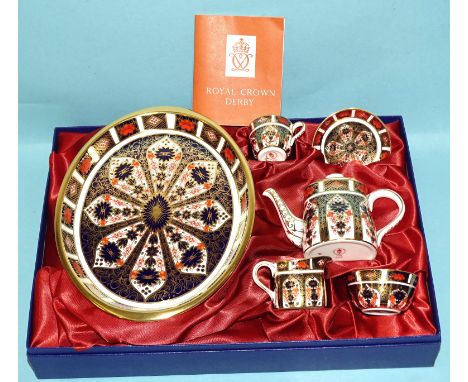 A Royal Crown Derby Imari miniature tea set, comprising oval tray, teapot, cup, saucer, milk jug and sugar bowl, all pattern 