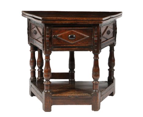 A 17TH CENTURY OAK CREDENCE CUPBOARD. having a trapezium shaped fold over top above diamond panels with a bulbous centres and