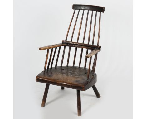 A 17TH CENTURY PRIMITIVE ELM STICK BACK ARMCHAIR, WELSH. having a curved cresting rail above turned spindles raised on a thic