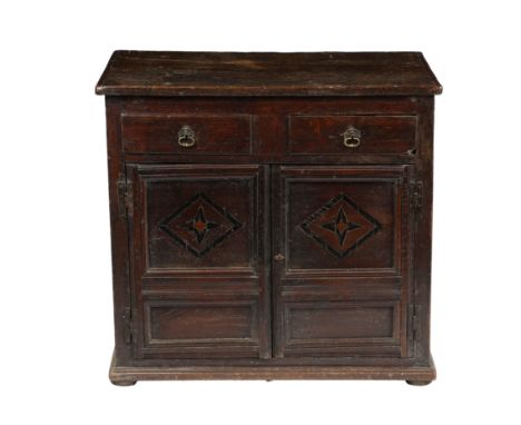 AN 18TH CENTURY OAK AND INLAID CUPBOARD, CIRCA 1700-20. having a two piece top above two drawers with brass handles and a pai