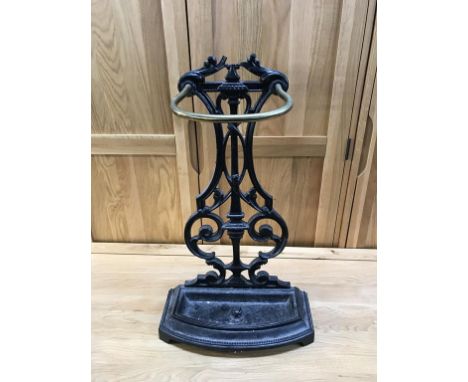 A cast iron and brass stick stand