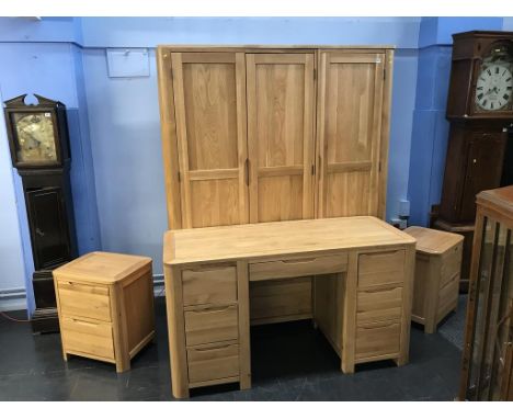 A modern light wood triple door wardrobe, a pair of bedside cabinets and a dressing table