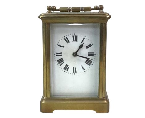 EDWARDIAN CARRIAGE CLOCK, with white enamel dial with Roman numerals, contained in a brass and bevelled glass case11cm high