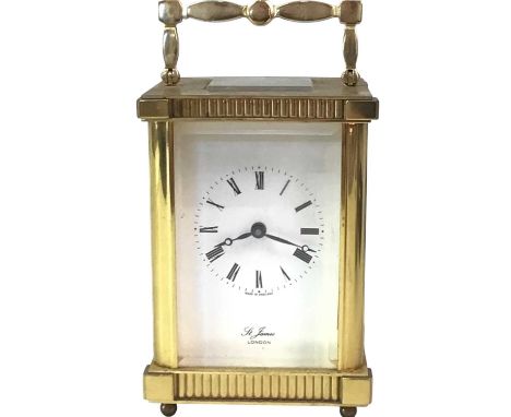 CARRIAGE CLOCK, the white enamel dial with Roman numerals, inscribed St. James London, contained in a brass and bevelled glas