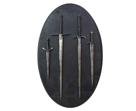 LORD OF THE RINGS WALL PLAQUE, THE ARMS OF THE NAZGUL of oval form, on black embossed resin backboard, depicting four swords;