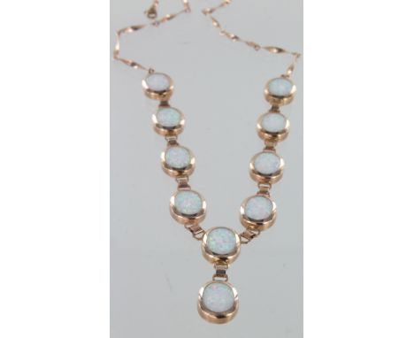 9ct rose gold Y shaped necklace with ten created opal oval stones, 18" long, 11.7g.