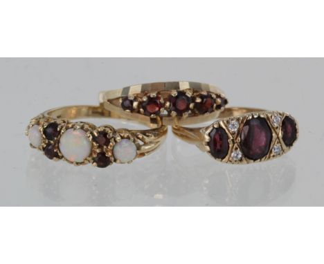 9ct garnet and cz ring, size L, weight 2.6g. 9ct garnet five stone ring, size P, weight 3.3g. 9ct opal and garnet ring, size 