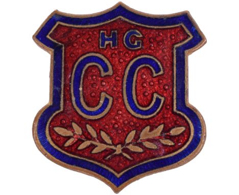 Enamel Lapel Badge, bearing a shield with HG C C and leaf spray. Pin back fitting to the reverse and stamped MADE IN ENGLAND.