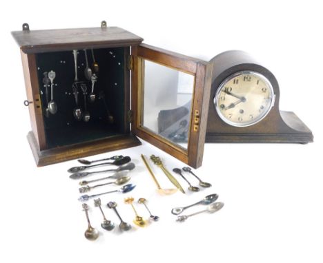 An early 20thC oak smoker's cabinet, with glazed door revealing a quantity of collectors spoons, lacking interior, and an oak