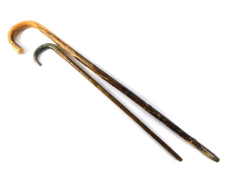 A horn handled walking stick, with gilt metal collar and bamboo style stem, 69cm long, further walking stick, and four variou