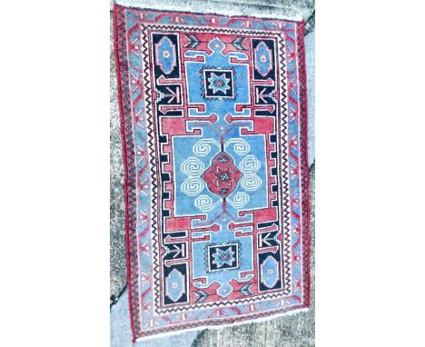 A vintage Hamadan village rug, with central medallion within compartments, in red, pale blue, etc., one wide, two narrow bord