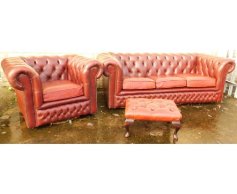 A three piece club style red leather lounge suite,  comprising three seater Chesterfield settee and armchair, each in button 