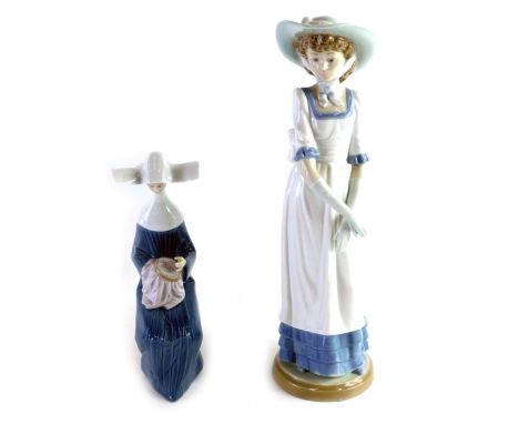 A Lladro figure of a seated nun sewing, and a Nao figure of a lady wearing bonnet, 33cm high. (2) 