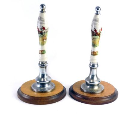 Two vintage ceramic and chrome beer pump pulls, with hunting scenes, marked 19.4.55, on inverted oak bases, 41cm high. 