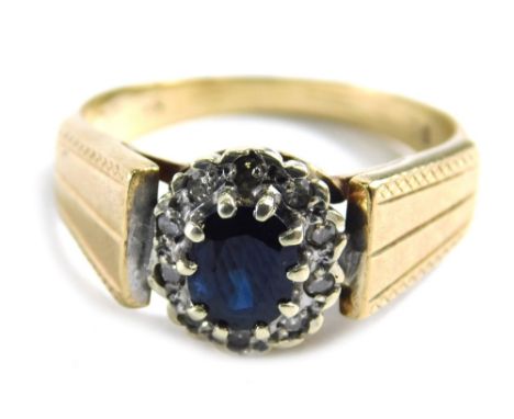 A 9ct gold sapphire and diamond dress ring, with oval sapphire in claw setting, surrounded by tiny diamonds in Art Deco style