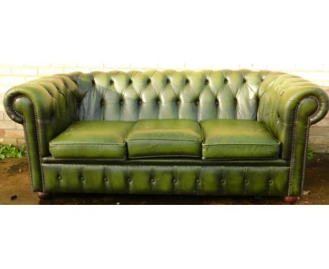 A 20thC green leather three seater Chesterfield Sofa, with button back and three cushions, on bun feet, 76cm high, 185cm wide