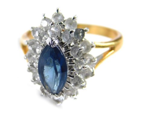 A dress ring, of two layered design with central blue paste stone set ring, on two colour plated band, ring size N. 