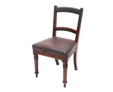 A Great Eastern Railways oak chair, with curved horizontal ladder back, overstuffed seat, in crimson leather on turned front 