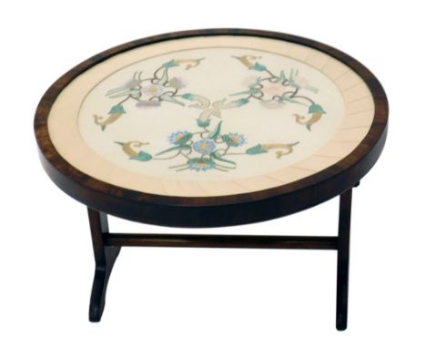 A walnut framed fire screen, with embroidered centre, on scroll feet, 66cm high. 